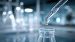 © EarthWalker - Glass lab dropper dispensing liquid into a flask. Chemical or medical laboratory setting
