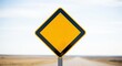 © Mey - A yellow diamond-shaped sign with black border on a desert road.