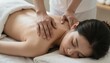 © BeeSee - woman receiving a back massage, a beautiful young woman with closed eyes relaxing on massage spa treatment on a blurred bright salon background, created with generative ai