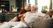 © peopleimages.com - Love, laugh or old couple on sofa with connection, romance or bonding together in retirement. Happy, elderly man or woman in house with embrace, marriage commitment or humor in romantic relationship.