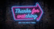 © UmmuAfifah - Vibrant neon sign displaying thanks for watching message on dark brick wall.