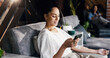 © peopleimages.com - Woman, relax and iv infusion with phone for communication, minerals and browsing website. Person, reading and mobile with injection drip for nutrition treatment, social media and article for wellness