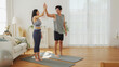 © eggeeggjiew - Asian man and woman celebrate workout achievement and high five together, showing fitness motivation and healthy lifestyle