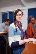 © Laflor2000/peopleimages.com - Portrait, college and woman in class with glasses, future or learning for academic success. Smile, confidence and scholar in classroom with specs, education and knowledge in university curriculum