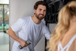 © zinkevych - Determined young man and woman exercising with dumbbells and looking contented