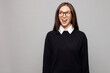 © ViDi Studio - Young happy shocked surprised successful employee business woman corporate lawyer wear black sweater shirt work in office look aside on area isolated on plain grey color background studio portrait.