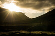 © Travel 'n' Lifestyle - View of the sun bursting through the clouds over the dark, rugged terrain of the Snaefellsnes Peninsula, a mystical landscape, Grundarfjordur, West Iceland, Iceland.