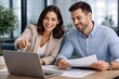 © ABUDARDA - Business professionals collaborating and discussing work on a laptop in a modern office setting