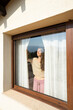 © Arianne - Woman enjoying morning sun at window