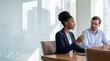 © Таня Андреева - Diverse professional colleagues, a Black woman and White man, in a strategic business meeting in a modern corporate boardroom.