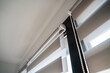 © Volodymyr_sh - Detail of zebra roller blinds mounting system and fabric texture on contemporary residential window