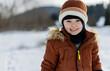 © leszekglasner - Adorable portrait of a smiling child in winter clothes walking in the snow