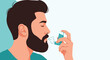 © Shoubj - Bearded man using a blue medical inhaler to breathe more easily during an asthma attack or respiratory distress.