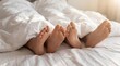 © ryker - Cozy feet under white duvet, intimate morning scene with sunlight and relaxed mood