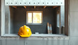 © Oksana - Industrial Concept Featuring A Yellow Safety Helmet Left On A Window Opening In A Developing Building
