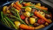 © VictorCanalesStudio - Cooking a healthy vegetarian dish with various roasted vegetables and herbs in a pan