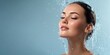 © Iryna - Young caucasian female enjoying refreshing splash of water on face in wellness setting