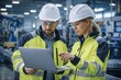 © jakir - Engineers reviewing data on laptop in industrial setting