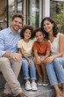 © thodonal - Joyful family portrait sitting on steps at home together