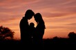 © Serhii - Golden hour family silhouette: parents with baby in a tender sunset moment