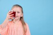 © New Africa - Little girl with glass of pomegranate juice on light blue background. Space for text