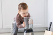 © New Africa - Child safety at home. Little boy playing with kitchen supplies indoors