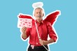 © Pixel-Shot - Senior man dressed as Cupid holding paper with lipstick kiss marks on blue background. Valentine's Day celebration