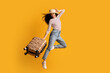 © Prostock-studio - Time To Travel. Full Length Shot Of Cheerful Excited Young Woman Wearing Wicker Hat Jumping With Suitcase Over Yellow Background, Happy Tourist Lady Ready For Summer Vacation Trip, Copy Space