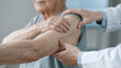 © MiMoShi - Professional physiotherapist treating elderly patient shoulder joint mobility exercise rehabilitation clinic healthcare medical assistance recovery therapy