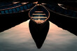 © Iain - A symmetrical composition of traditional wooden rowboats floating on still water, creating a mirror-like reflection.