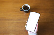 © Farknot Architect - Top view mockup image of a woman holding mobile phone with blank desktop screen