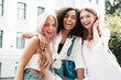 © halayalex - Three young beautiful smiling hipster female in trendy summer clothes.Sexy carefree multiracial women posing on the street background.Positive models having fun