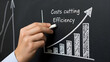 © Aldi12 - Business growth and cost cutting efficiency graph on blackboard