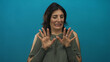 © Krakenimages.com - Middle aged woman pulling back hands toward camera with cringing expression in studio setting; disgust.