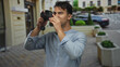 © Krakenimages.com - Young hispanic man with camera navigates city street capturing urban scenery, reflecting concentration and creativity in an outdoor setting.
