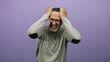 © Krakenimages.com - Mature man with glasses holding his head in frustration against a purple background, expressing stress and concern.
