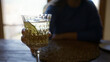 © Krakenimages.com - Woman enjoying vermouth in a mediterranean restaurant, holding a decorative glass indoors, showcasing a young hispanic beautiful scene with a relaxed atmosphere.
