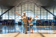 © efired - Female tourist and her son with raised arms in airport