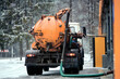 © Tricky Shark - Vacuum truck pumping out liquid waste and silt from self service car wash drainage system during winter to ensure proper filtration and wastewater disposal services, cleaning of car wash facility
