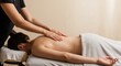 © D-point - Woman receiving a back massage in a spa salon. Female therapist massaging girl body. Relax, wellness and health concept.