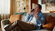 © stockbusters - Home man talking cellphone relaxing on apartment sofa closeup. Guy have call