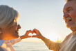 © Юлия Завалишина - Love heart shape peace. Senior older couple making heart shape with their hands. Adult mature old husband wife showing heart sign. Happy pensioner family. I love you happy valentines day
