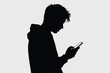 © Aashutosh Pandit - Silhouette of young man using mobile phone for social media communication and digital connection in modern lifestyle concept for technology advertising and online marketing with focus on youth culture
