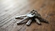 © Fadila - Set of silver keys on a wooden surface