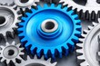 © Lubos Chlubny - Blue gear standing out among metal cogs
