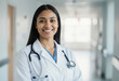 © Janis - Woman in white lab coat smiling with stethoscope