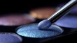© Moddy - Ethereal hues of beauty: An eye shadow palette offers a range of vibrant colors for beauty and glamour and a professional makeup brush is poised above the dazzling shades.