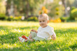 © Tina kids photo - little blond boy in a cotton suit in the summer on a park lawn