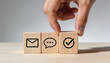 © Art_spiral - Hand arranging wooden blocks with email chat and check icons for customer service communication support approval and feedback concept minimal neutral background