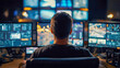 © Daria - Technician monitoring multiple digital screens displaying data and surveillance footage in a high-tech control room environment during nighttime hours